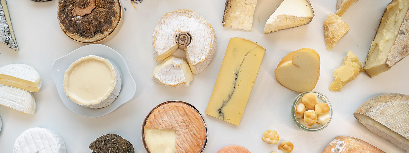 Bild von einer großen Käseplatte mit vielen angeschnittenen Käsen